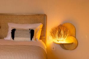 a bedroom with a bed with a pillow and a lamp at Naif Hotel - Adults Only in Göreme