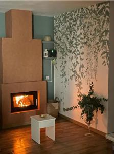 a living room with a fireplace and a plant at Loft Ben A Ocaz in Benaocaz