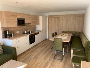 a kitchen and dining room with a table and chairs at Haus Erwin Appartement in Sölden