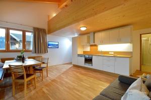 a kitchen and living room with a table and chairs at Appartment Bichler in Hopfgarten im Brixental +13 photos