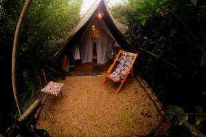 an overhead view of a tent with a chair in front at Glamping Tierra Dulce in Supatá
