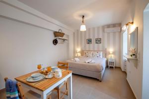 a bedroom with a bed and a table and a bed and a dining room at Sweet Dreams in Gaios