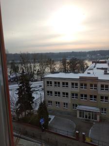 a view of a building with snow on the roof at Familijny in Toruń
