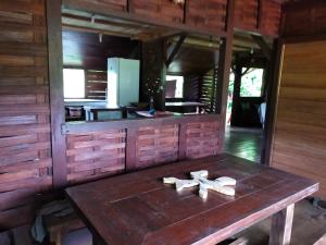 a kitchen with a wooden table with two crosses on it at Chez Faby in Saül
