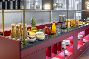 a buffet with food and drinks on a table at NH Collection Salzburg City in Salzburg