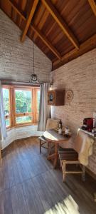 a living room with a table and a couch at Pousada Canto do Sabiá in Monte Verde