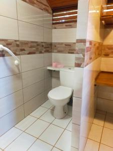 a bathroom with a white toilet in a room at Chez Faby in Saül