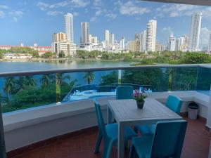 een balkon met een tafel en stoelen en uitzicht op de stad bij Apartamento Mirador Del Laguito in Cartagena