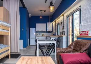 a kitchen with a couch and a table in a room at Stara Olejarnia in Nowe Miasto Lubawskie