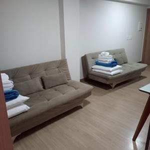 a living room with a couch and a chair at Apartamento Hotel Vista Azul - Pedra Azul - ES in Domingos Martins