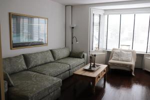 a living room with a couch and a chair at Bed & Breakfast Hotel Zandvoort in Zandvoort