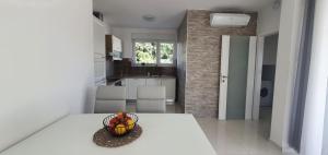a kitchen with a bowl of fruit on a table at Seastar Luxury apt with PRIVATE POOL and sea view in Novalja