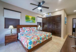 a bedroom with a bed and a ceiling fan at Penthouse Reef 401 - Beautiful Beachfront Ocean View - at El Faro in Playa del Carmen