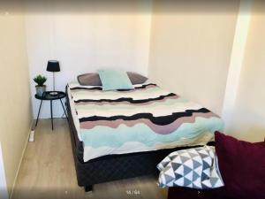a bed in a small room with at Scandinavian Desing Home 37 City Center in Kamppi in Helsinki
