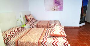 a bed and a couch in a room at Casa del Sur, en el Sur de Tenerife in Granadilla de Abona