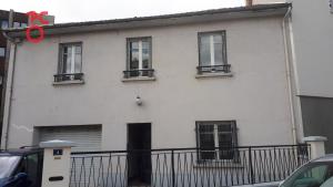 a white building with windows and a pair of red scissors at Le Pop'Art - Rent4night Grenoble in Grenoble