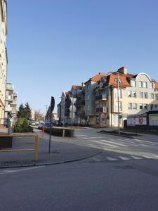 an empty city street with buildings in the background at Apartament Kotwica in Giżycko