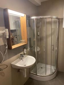 a bathroom with a shower and a sink at Brzece Apartman 23 in Mramor