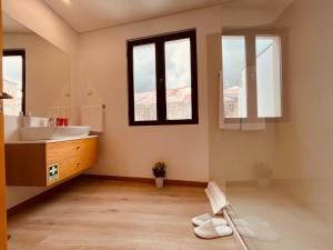 a bathroom with a sink and a mirror at Living Funchal X in Funchal +56 photos