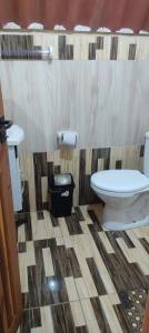 a bathroom with a toilet and a sink at Chalé Barco da areia in São Mateus +34 photos