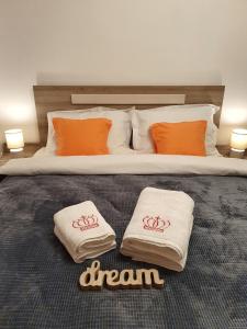 a bedroom with a bed with orange and white pillows at ARTment! A new and stylish apartment for you - Free parking in Braşov