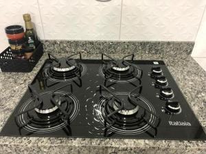 a stove top with four burners on a counter at Casa dos Ventos Barreirinhas in Barreirinhas