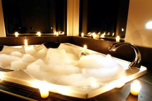 a bath tub filled with candles in a bathroom at Millton Park Estate in Invercargill