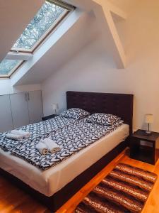 a bedroom with a large bed in a attic at Sara Apartment in Belgrade