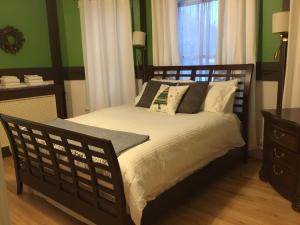 a bed in a room with green walls at Marmora and Lake Inn and Victorian Diner in Marmora