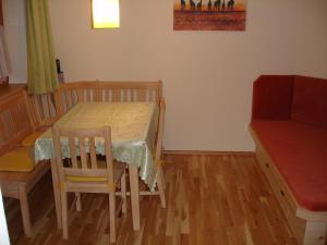 a room with a table and a chair and a table and a table at Haus Gföller in Niederau