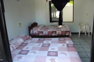 Ένα ή περισσότερα κρεβάτια σε δωμάτιο στο Hotel Palmarito