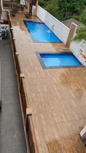 an overhead view of two swimming pools on a deck at Pousada Manancial in Itaúnas