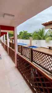 a balcony of a resort with a swimming pool at Pousada Manancial in Itaúnas