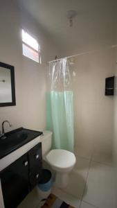 a bathroom with a toilet and a shower and a sink at Pousada Manancial in Itaúnas +35 photos