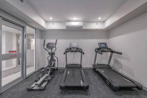 a gym with three tread machines in a room at Vita Resort on Lake Okanagan in Vernon