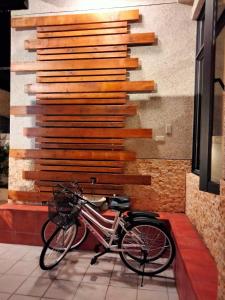 a bike parked in front of a wall of wood at 910 Hostel 城南館-自助入住 in Yuli
