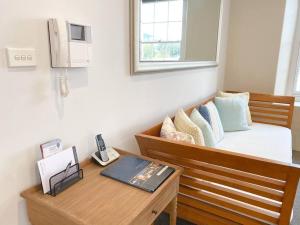 a room with a bed and a table with a desk sidx sidx sidx at Luxury Hobart Waterfront Apartment with views! in Hobart
