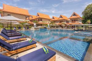 uma imagem de uma piscina num resort em The Salila Beach Resort em Seminyak