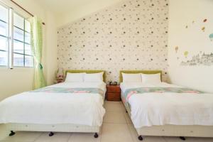 Cama ou camas em um quarto em Ying Hsuan House