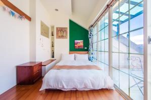 Cama ou camas em um quarto em Ying Hsuan House