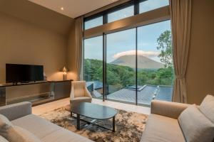 a living room with a view of a mountain at Boheme by H2 Life in Kutchan
