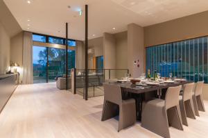 a dining room with a table and chairs at Boheme by H2 Life in Kutchan +21 photos