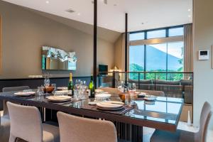 a dining room with a large table and chairs at Boheme by H2 Life in Kutchan