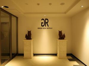 a museum with two statues of cats on a wall at Green Rich Hotel & Capsule Naha - Artificial hot spring Futamata Yunohana in Naha +95 photos