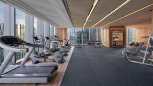 a gym with a lot of treadmills and machines at The Langham, Jakarta in Jakarta