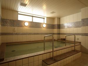 a large swimming pool in a bathroom with a window at Green Rich Hotel & Capsule Naha - Artificial hot spring Futamata Yunohana in Naha