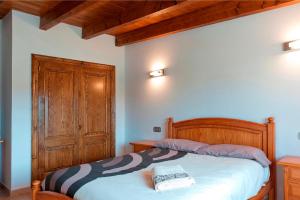 a bedroom with a bed and a wooden door at Sestados in Sa Pobla +21 photos