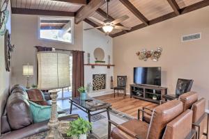 a living room with a couch and a tv at Condo with Mtn Views, Balcony and Hot Tub Access! in Sedona