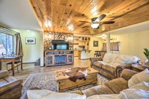 a living room with a couch and a table at Show Low Cabin with BBQ and Fire Pit Pets Welcome! in Show Low