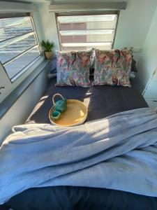 Letto o letti in una camera di Alice & Elvis, Crescent Head, Retro Caravans with Deck, Bathroom & Outdoor Bath in a Bush Setting near the Beach